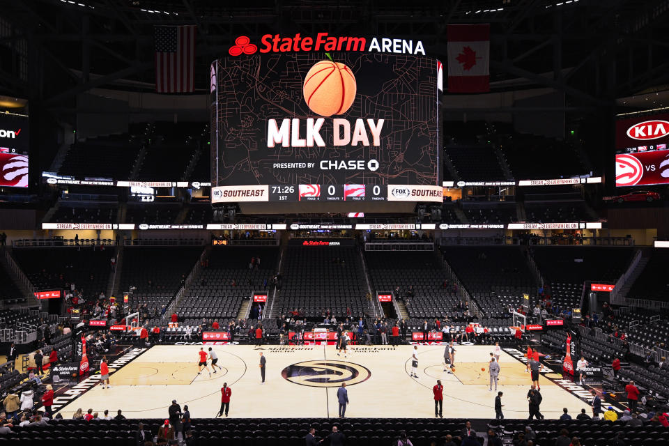 Players with the Atlanta Hawks and the Toronto Raptors warm up before an annual Dr. Martin Luther King Jr. Day afternoon NBA basketball game, Monday, Jan. 20, 2020, in Atlanta. (AP Photo/John Amis)