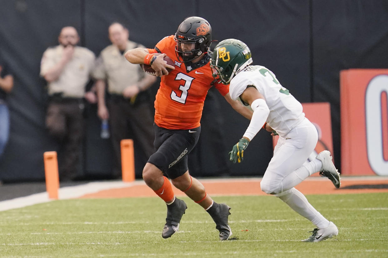 Oklahoma State quarterback Spencer Sanders (3) carries the ball during a matchup against Baylor on Oct. 2, 2021, in Stillwater, Okla. (AP Photo/Sue Ogrocki)