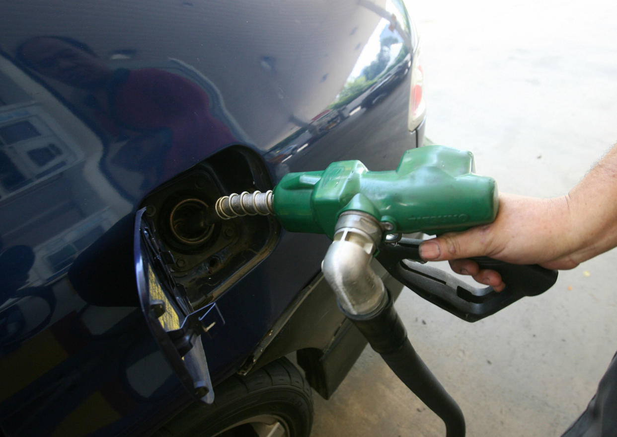 A pump attendant fills up fuel to a car at a petrol station in Singapore.