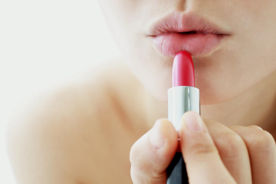 woman applying lipstick