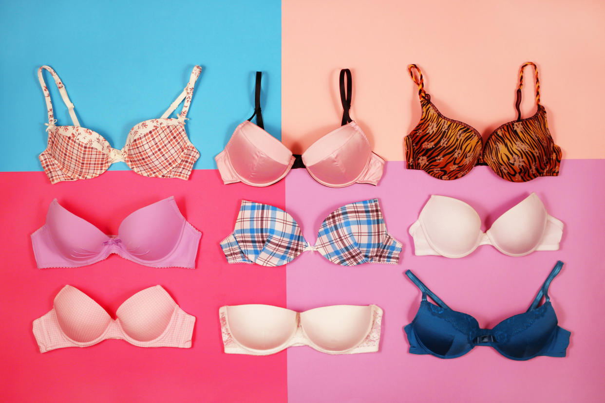 Set of different bras on multicolored background