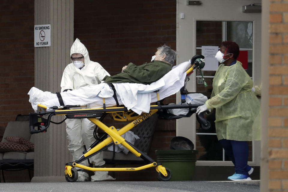 A resident is removed from the Gallatin Center for Rehabilitation and Healing Monday, March 30, 2020, in Gallatin, Tenn. Multiple people tested positive for the coronavirus at the facility Friday. Tennessee Gov. Bill Lee issued a statewide "safer-at-home" order on Monday to help stem the state's rapid spread of coronavirus, mandating the closure of all nonessential businesses while urging residents to remain at home whenever possible for the next two weeks. (AP Photo/Mark Humphrey)