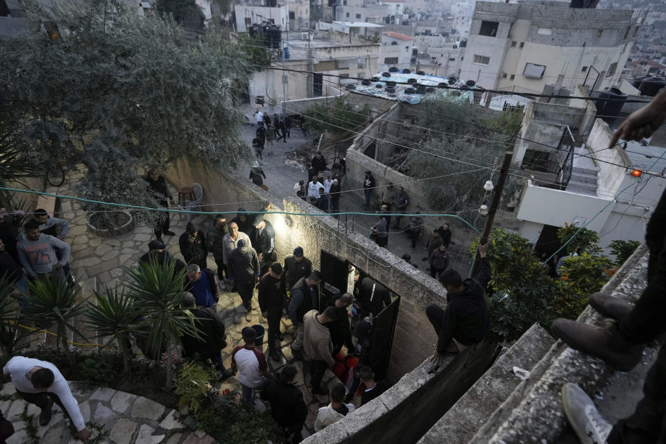 Palestinians inspect the site of a damaged building following an Israeli forces raid in the West Bank city of Jenin, Tuesday, March 7, 2023. The Israeli army has raided the occupied West Bank city of Jenin, leading to a gunbattle that killed at least six Palestinians, Israeli officials said the target of the raid was a militant who killed two Israeli brothers in a West Bank shooting last week. The man was among those killed on Tuesday. (AP Photo/Majdi Mohammed)