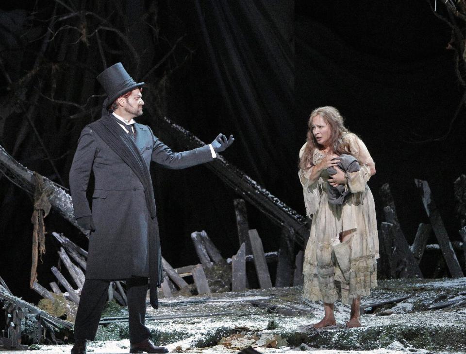 This undated publicity photo provided by the San Francisco Opera shows Ildar Abdrazakov as Mefistofele and Patricia Racette as Margherita in Act III during the dress rehearsal of "Mefistofele," in San Francisco. (AP Photo/Copyright San Francisco Opera, Cory Weaver)