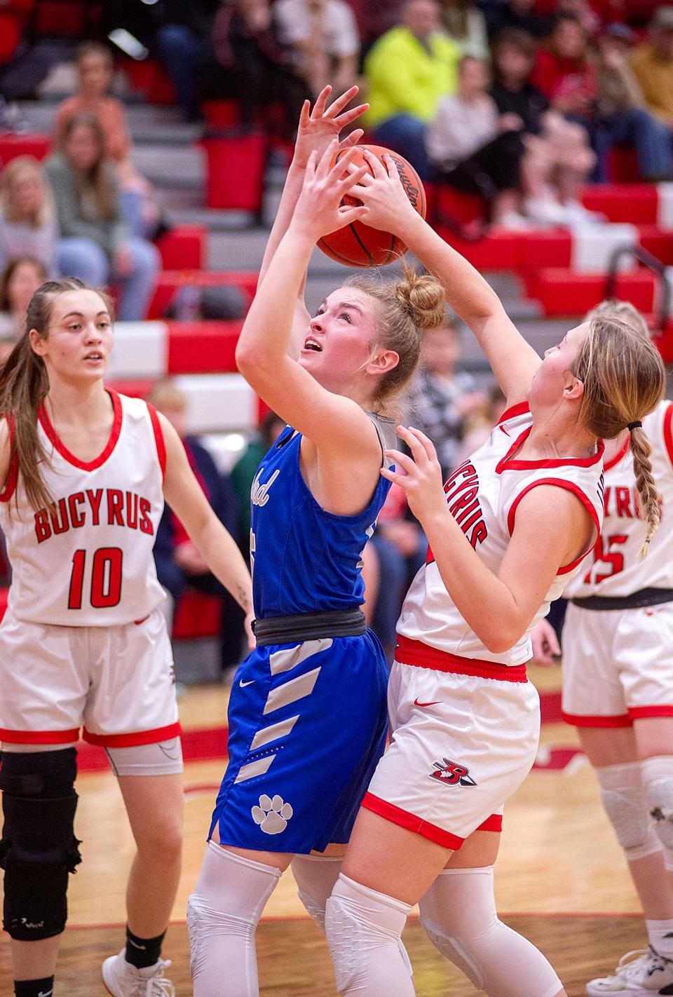 Wynford's Grace Stucky struggles for the ball with Bucyrus' Madalyn Kimmel.