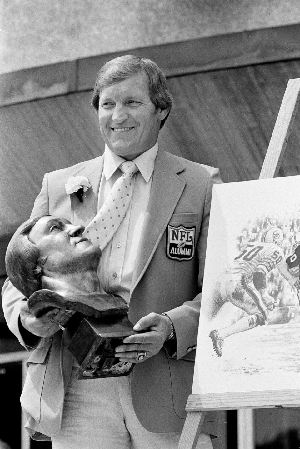 Jim Otto poses with his bust after being enshrined in the Pro Football Hall of Fame on Aug. 2, 1980, in Canton, Ohio.