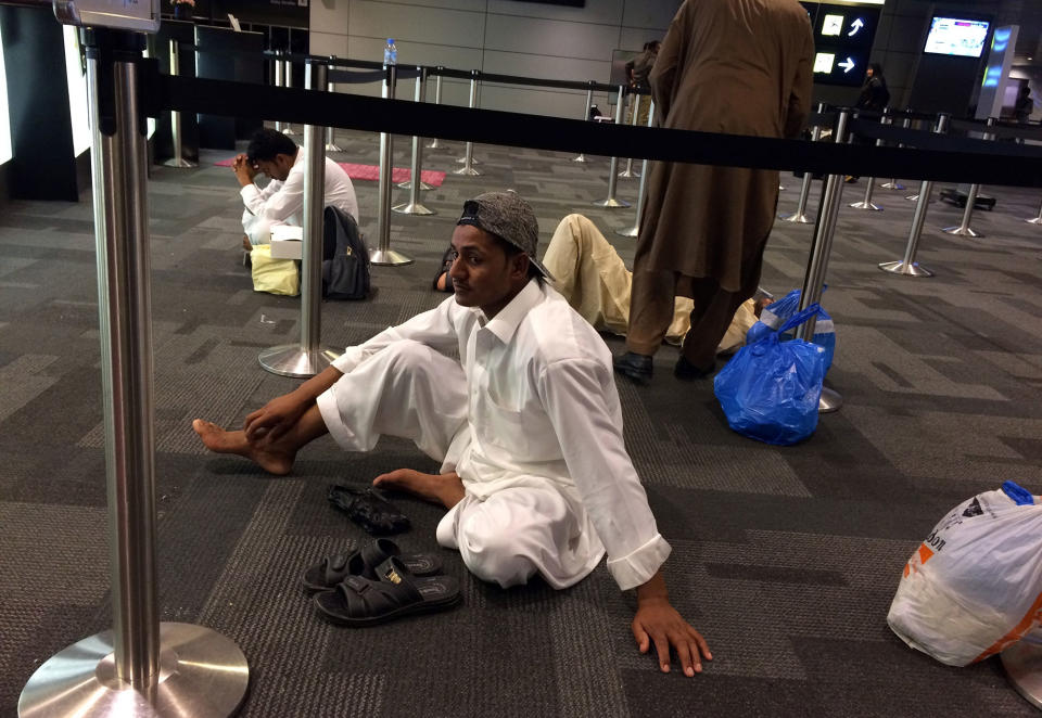 Passengers of cancelled flights wait in Hamad International Airport