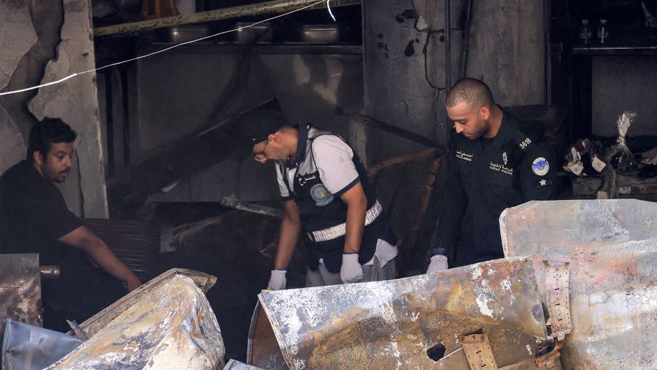 Kuwaiti security forces gather at the building that was engulfed by fire in Kuwait City, on June 12, 2024. - Yasser Al-Zayyat/AFP/Getty Images