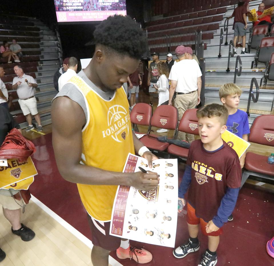 Iona basketball's Comeh Emuobor signs autographs after an open practice at Hynes Athletic Center in New Rochelle, Aug. 3, 2024.