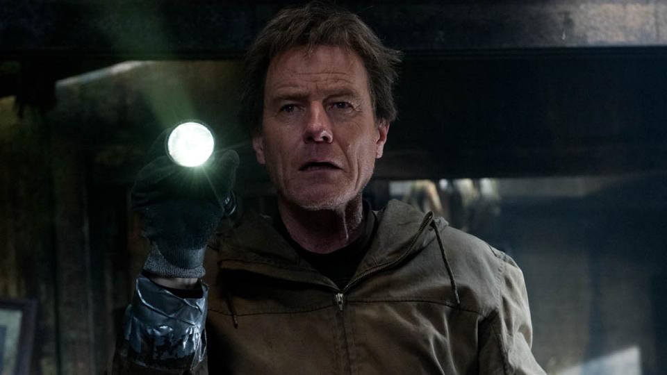 Bryan Cranston stands in a ruined home in Godzilla