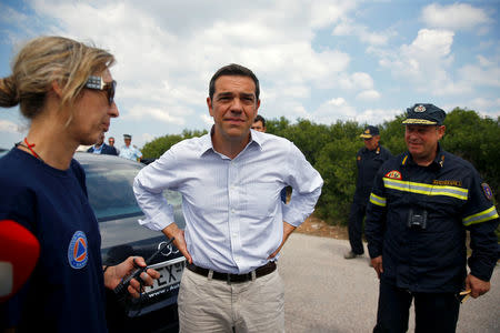 Greek Prime Minister Alexis Tsipras meets with firefighters as a wildfire is being contained after four days near the village of Kapandriti, north of Athens, Greece August 16, 2017. REUTERS/Murad Sezer