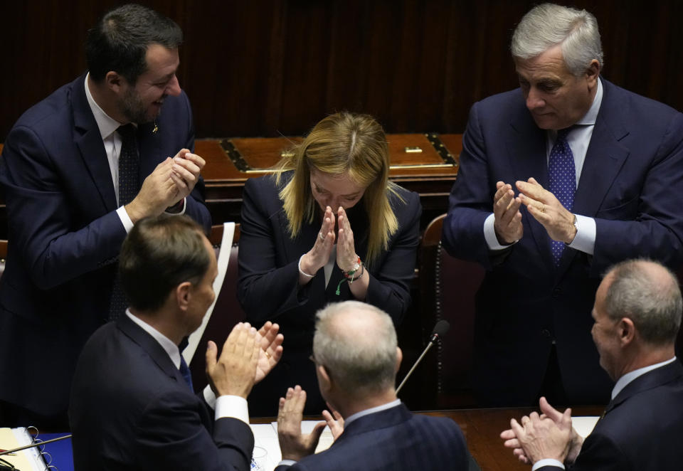 FILE - Italian Premier Giorgia Meloni, center, acknowledges the applause after addressing the lower Chamber ahead of a confidence vote for her cabinet in Rome, Tuesday, Oct. 25, 2022. When Giorgia Meloni took office a year ago as the first far-right premier in Italy's post-war history, concern was palpable abroad about the prospect of democratic backsliding and resistance to European Union rules. But since being sworn in as premier on Oct. 22, 2022, Meloni has confounded Western skeptics. (AP Photo/Alessandra Tarantino, File)