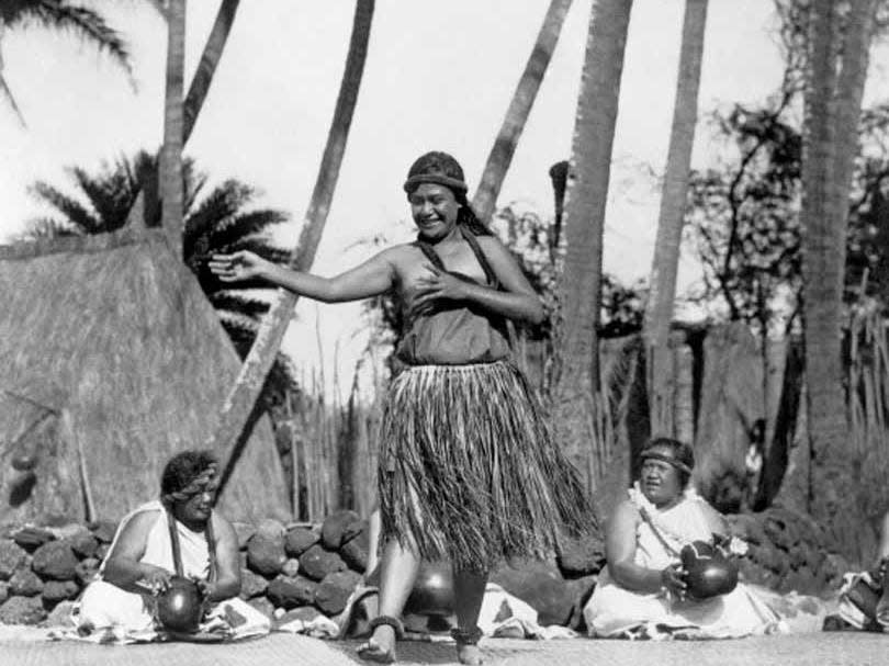 Getty Images A native Hawaiian dancer performing while other women keep rhythm with gourds, Hawaii, circa 1924