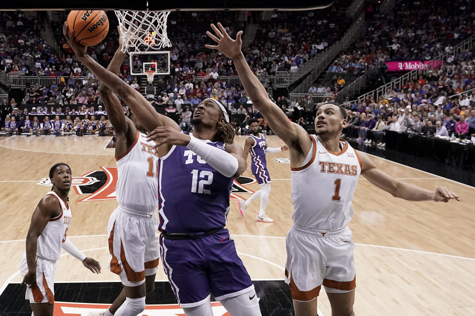 TCU forward Xavier Cork (12) puts up a shot during the second half of an NCAA college basketball game against Texas in the semifinal round of the Big 12 Conference tournament Friday, March 10, 2023, in Kansas City, Mo. (AP Photo/Charlie Riedel)