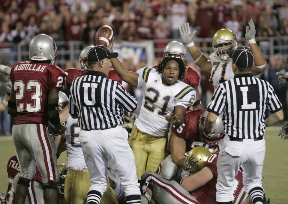 UCLA tailback Maurice Drew (21) celebrates his overtime touchdown against Washington State