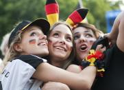 Fans celebrate after the 2014 World Cup quarter-final soccer match between Germany and France at the Fanmeile public viewing arena in Berlin July 4, 2014. REUTERS/Steffi Loos