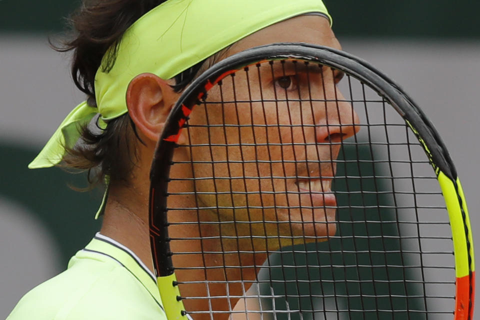 FILE - In this Friday, June 7, 2019, file photo, Spain's Rafael Nadal grimaces after scoring against Switzerland's Roger Federer during their semifinal match of the French Open tennis tournament at Roland Garros stadium in Paris. Nadal can pull even with Roger Federer for most Grand Slam singles titles won by a man by collecting No. 20 at the French Open. (AP Photo/Michel Euler, FIle)