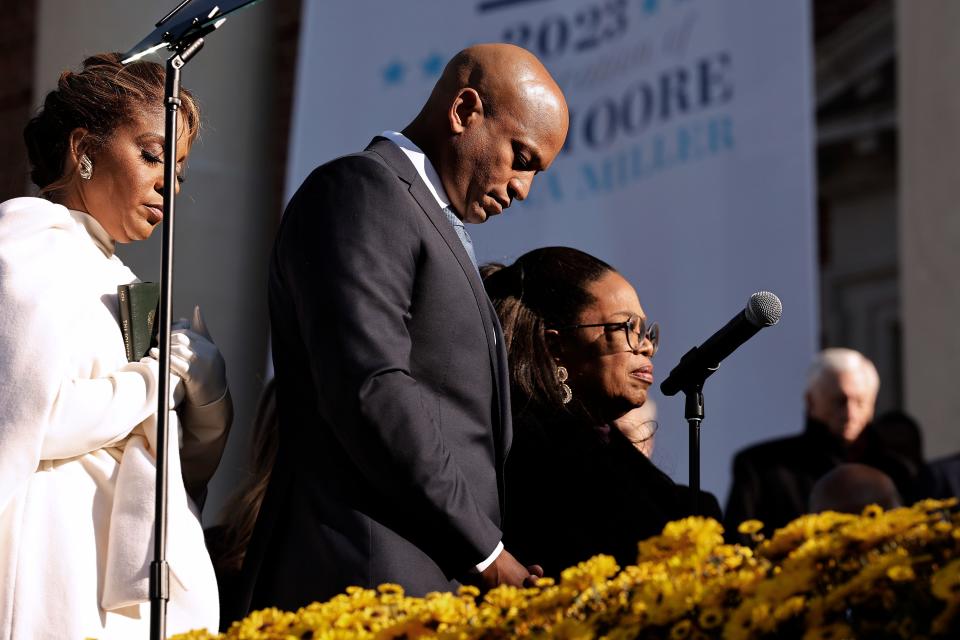 Maryland Governor Wes Moore (C), first lady Dawn Moore (L) and Oprah Winfrey bow their heads in prayer at the conclusion of his inaugural ceremony at the Maryland State House on January 18, 2023 in Annapolis, Maryland. Democrat Moore defeated Republican nominee Dan Cox to become the first Black governor of Maryland and only the third Black person to be elected governor in the United States.