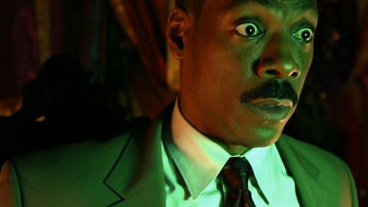 eddie murphy looks shocked in a scene from the hunted mansion a good housekeeping pick for best halloween movies