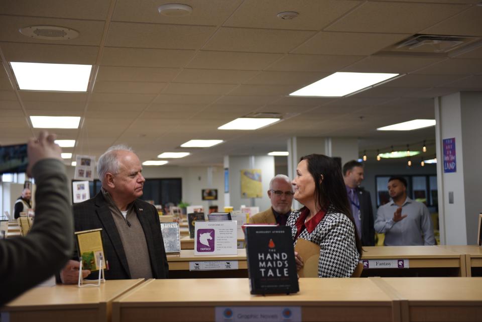 Minnesota Democratic Gov. Tim Walz speaks to a library specialist at Como Senior High School in St. Paul, Minn. about his proposal to prohibit book banning on March 21, 2024.