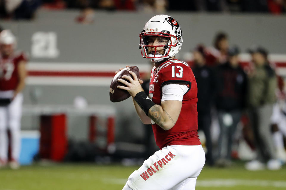 North Carolina State quarterback Devin Leary (13) looks to throw the ball against Syracuse during the second half of an NCAA college football game in Raleigh, N.C., Saturday, Nov. 20, 2021. (AP Photo/Karl B DeBlaker)