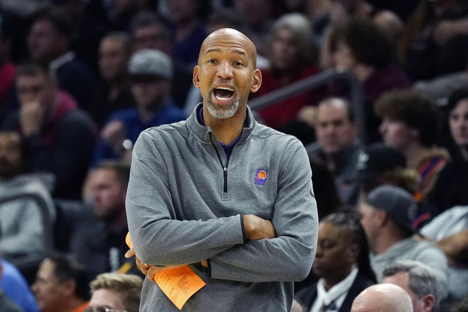 Phoenix Suns coach Monty Williams talks with his players on the court during the first half of the team's NBA basketball game against the Chicago Bulls in Phoenix, Wednesday, Nov. 30, 2022. The Suns won 132-113. (AP Photo/Ross D. Franklin)