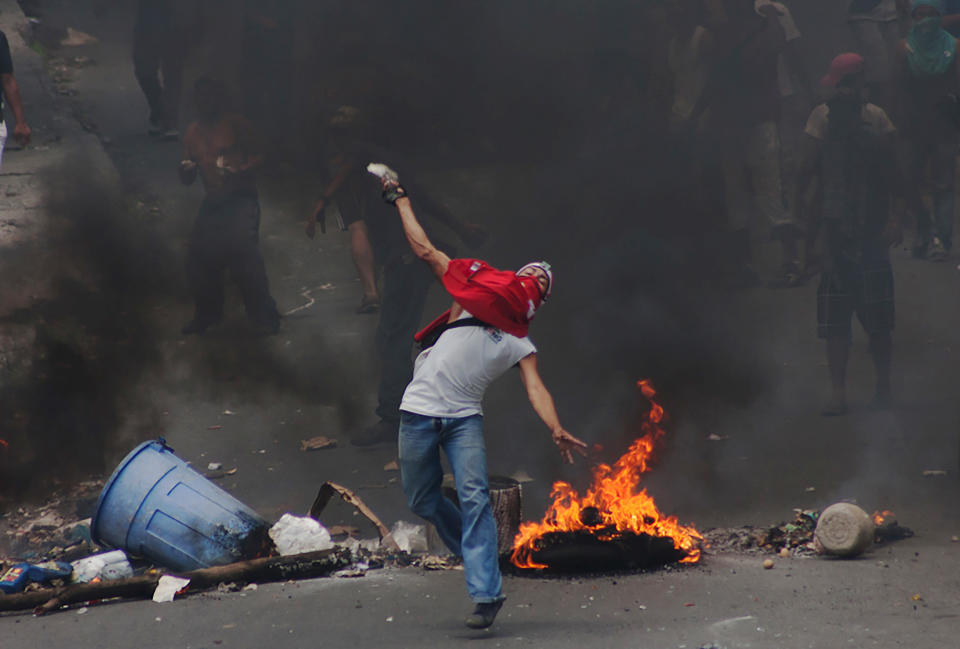 Protesters clash with riot police during a demonstration in Caracas on June 10, 2016.