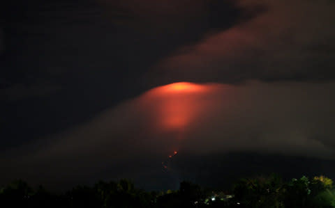 The Mayon volcano's crater glows, as it is pictured from Daraga, Albay, the Philippines - Credit: Reuters