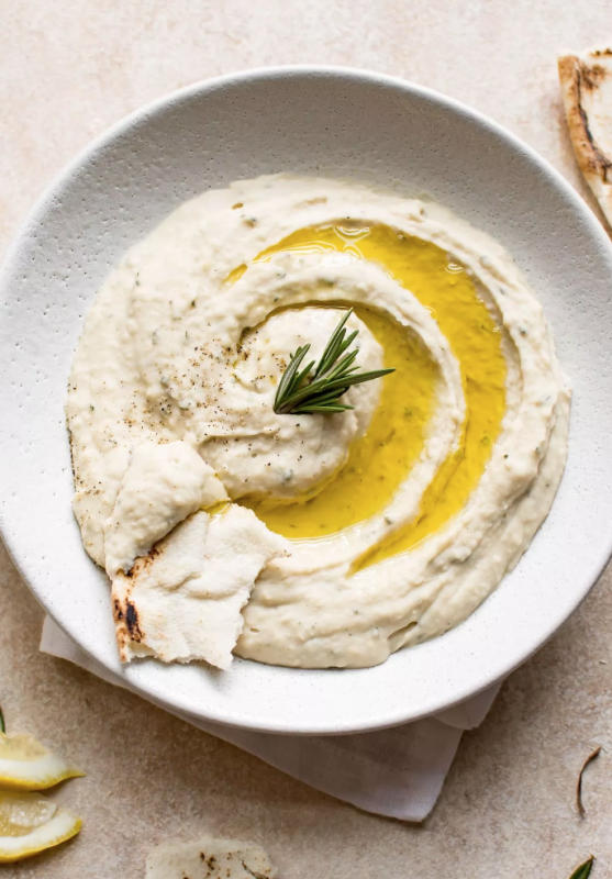 <p>Salt and Lavender</p><p>This rosemary white bean dip makes a tasty little snack or appetizer. A great addition to a party platter or cheese board for easy entertaining!</p><p><strong>Get the recipe: <a href="https://www.saltandlavender.com/rosemary-white-bean-dip/" rel="nofollow noopener" target="_blank" data-ylk="slk:Rosemary White Bean Dip;elm:context_link;itc:0;sec:content-canvas" class="link "><em>Rosemary White Bean Dip</em></a></strong></p>