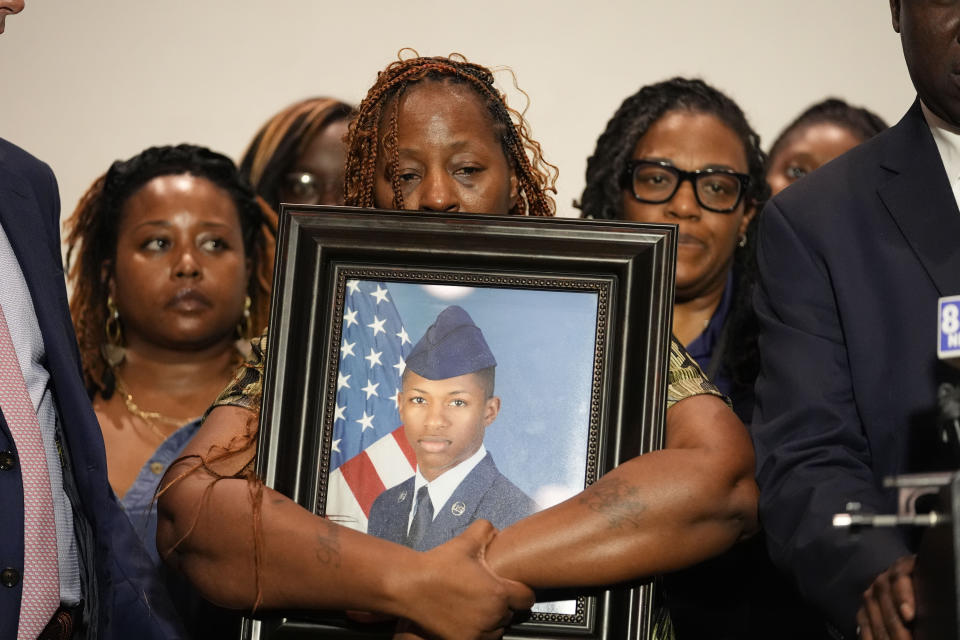 Chantemekki Fortson, mother of Roger Fortson, a U.S. Navy airman, holds a photo of her son during a news conference with Attorney Ben Crump, Thursday, May 9, 2024, in Fort Walton Beach, Fla. Fortson was shot and killed by police in his apartment on May 3, 2024. (AP Photo/Gerald Herbert)