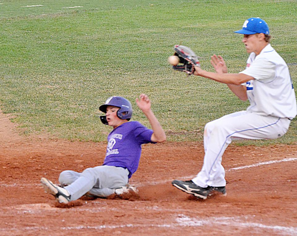 Watertown Red Sox base runner Blake Davis slides into the plate ahead of the throw to Renner pitcher Cooper Bielitz during their game Friday night in the state Class A Baseball 16-and-under tournament in Watertown. The Red Sox finished 1-2 in the tourney.