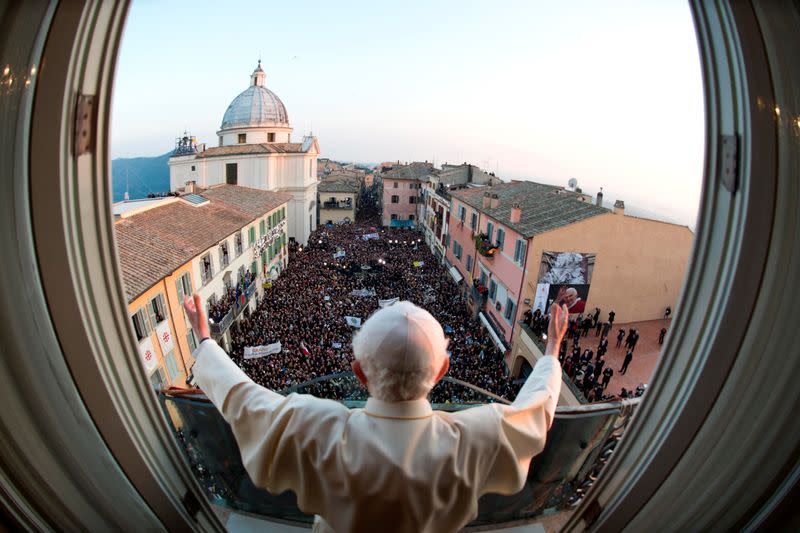 FILE PHOTO: Pope Benedict XVI waves as he appears for the last time at the balcony of his summer residence in Castel Gandolfo