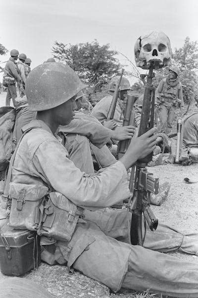 A young Khmer Rouge soldier. <a href="https://www.gettyimages.com/detail/news-photo/with-a-skull-on-the-muzzle-of-his-m-16-rifle-a-khmer-rouge-news-photo/515109502?adppopup=true" rel="nofollow noopener" target="_blank" data-ylk="slk:Bettmann/Getty Images;elm:context_link;itc:0;sec:content-canvas" class="link ">Bettmann/Getty Images</a>