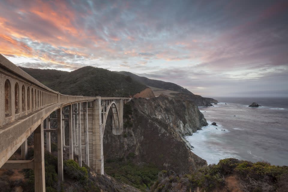 Completed in 1932, the Bixby Bridge is one of the highest bridges of its kind in the world and makes for a stunning sunset snap.  Photo: Getty