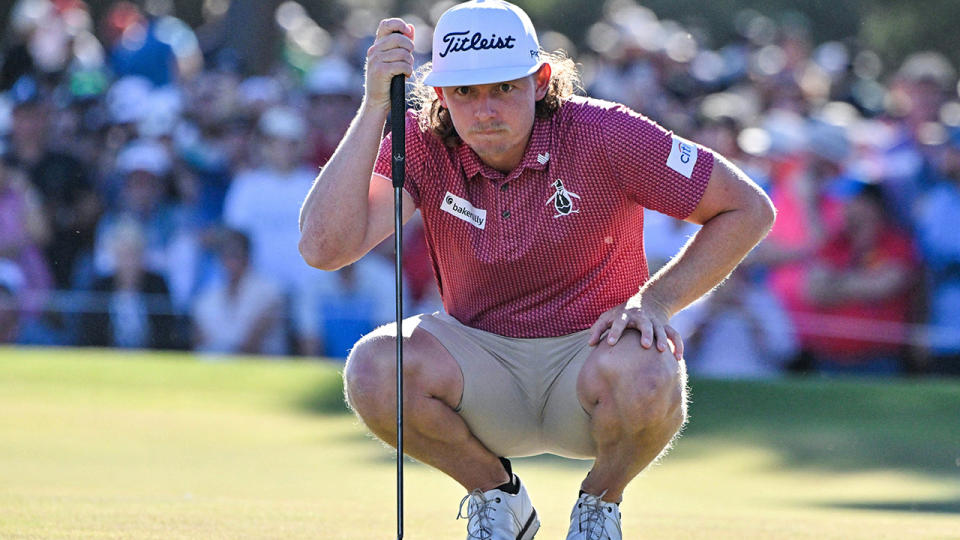 Cameron Smith measures a putt.