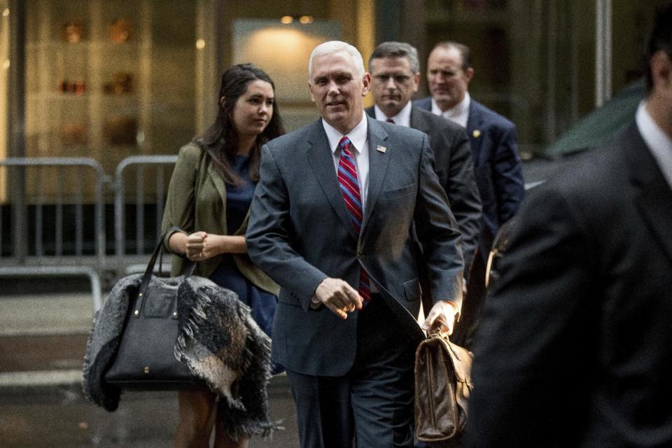Vice President-elect Mike Pence, center, accompanied by his daughter Audrey, left, arrives at Trump Tower in New York, Tuesday, Jan. 3, 2017. (AP Photo/Andrew Harnik)