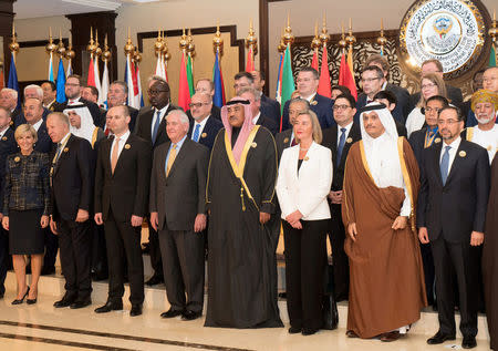 FILE PHOTO: Kuwait's Minister of Foreign Affairs Sheikh Sabah al Khalid Al Sabah, U.S. Secretary of State Rex Tillerson, European High Representative for Foreign Affairs Federica Mogherini, Qatari Foreign Minister Sheikh Mohammed bin Abdulrahman Al Thani and other delegates pose for a group photo ahead of the Kuwait International Conference for Reconstruction of Iraq, in Bayan, Kuwait February 13, 2018. REUTERS/Stephanie McGehee/File Photo