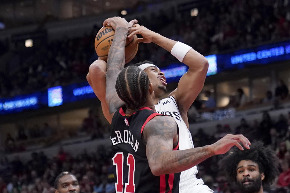 Chicago Bulls' DeMar DeRozan (11) blocks a shot by San Antonio Spurs' Keldon Johnson during the first half of an NBA basketball game Thursday, Dec. 21, 2023, in Chicago. (AP Photo/Charles Rex Arbogast)