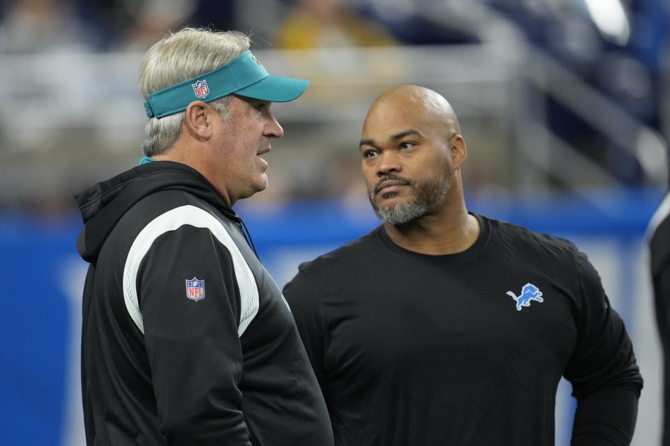 Jacksonville Jaguars coach Doug Pederson, left, talks with Detroit Lions assistant Duce Staley during pregame Dec. 4, 2022, in Detroit.