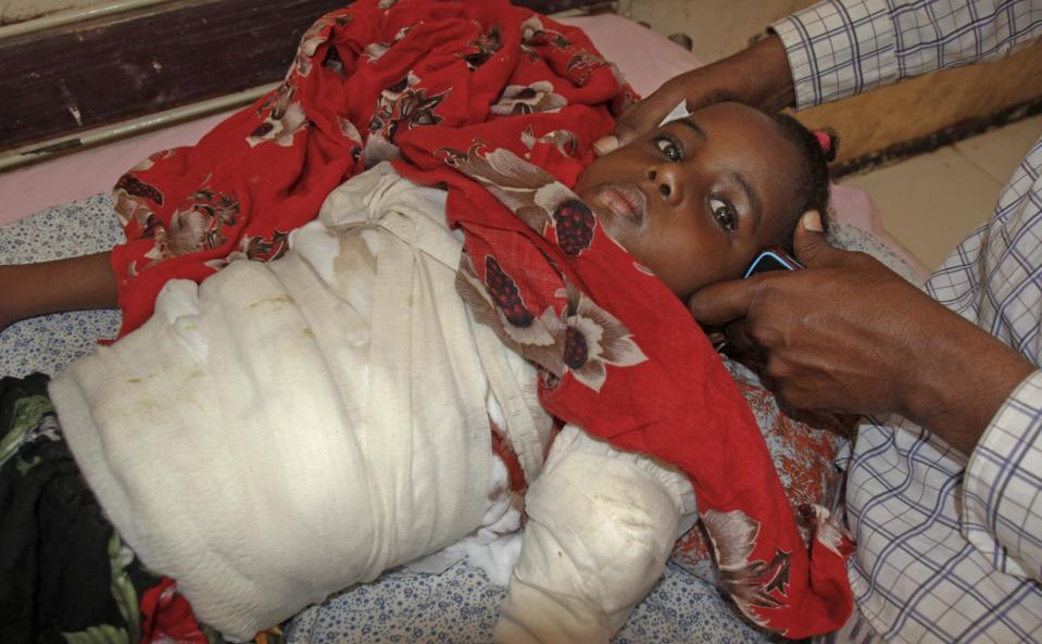 Ikran Hassan, 7, who was wounded in a mortar attack, receives treatment at the Madina Hospital in the capital Mogadishu, Somalia Wednesday, Feb. 5, 2014. Mortar fire from Islamic extremists has pummeled large parts of the Somali capital two nights this week, raising fears among residents of a return to the days of constant conflict and prompting government and security officials to spring into action. (AP Photo/Farah Abdi Warsameh)