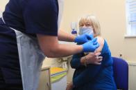 Elizabeth Van Tam, 79, the mother of Jonathan Van-Tam, deputy chief medical officer for England, is vaccinated against coronavirus at the the Jenner Health Centre in Whittlesey, Cambridgeshire