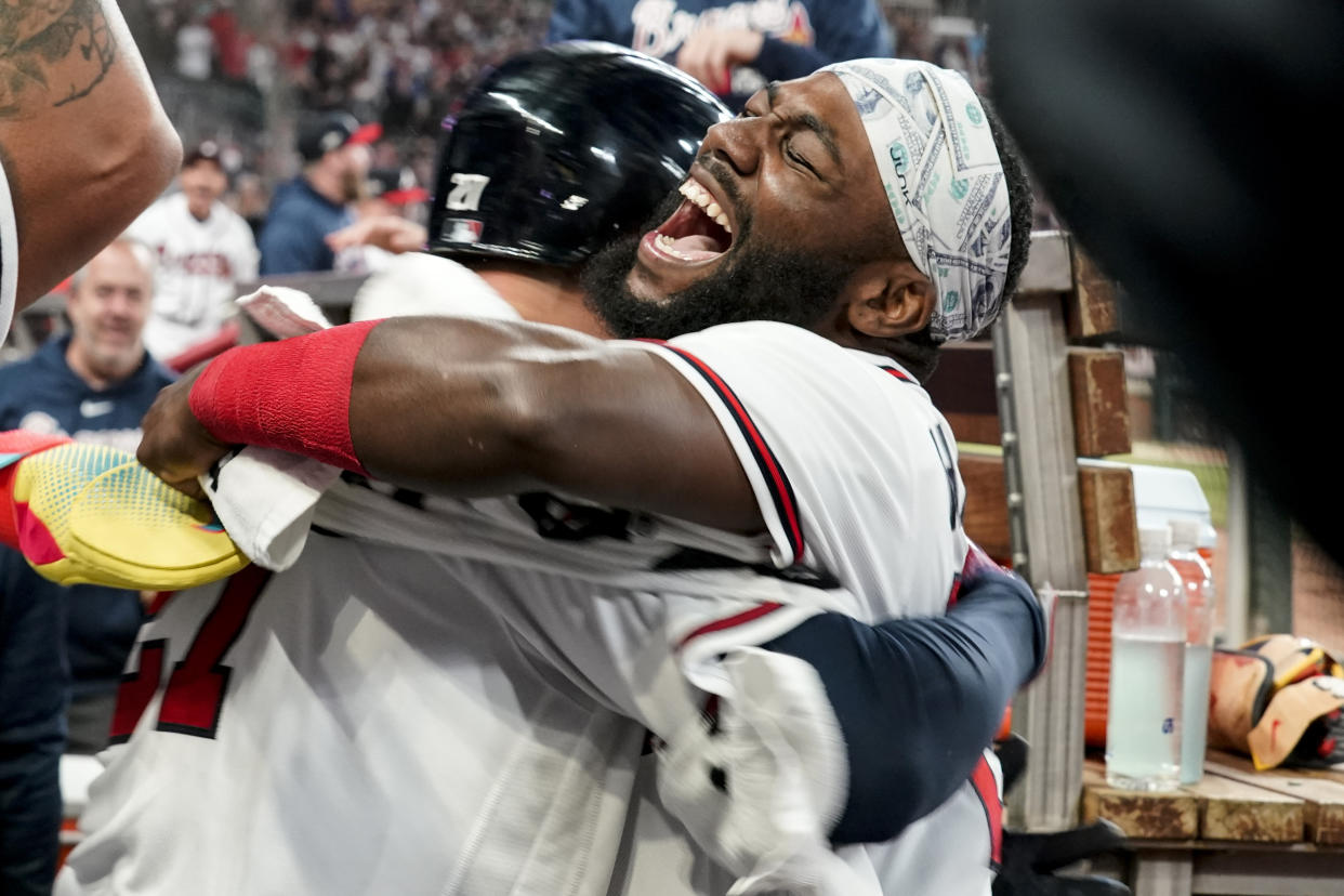 Outfielder Michael Harris II, right, celebrates with the Braves' other hero of Game 2, third baseman Austin Riley, after Riley's eighth-inning home run. (AP Photo/Brynn Anderson)
