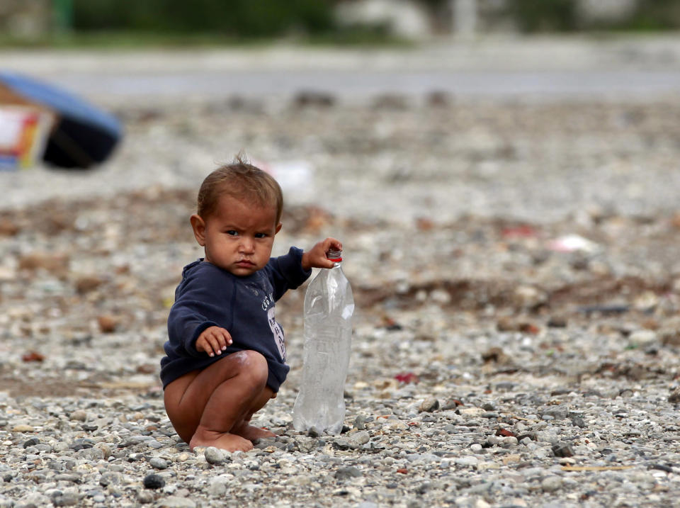 A Roma child, a refugee from Kosovo, plays with a plastic bottle at the camp Vrela Ribnicka in Podgorica, October 13, 2012. REUTERS/Marko Djurica (MONTENEGRO - Tags: SOCIETY)