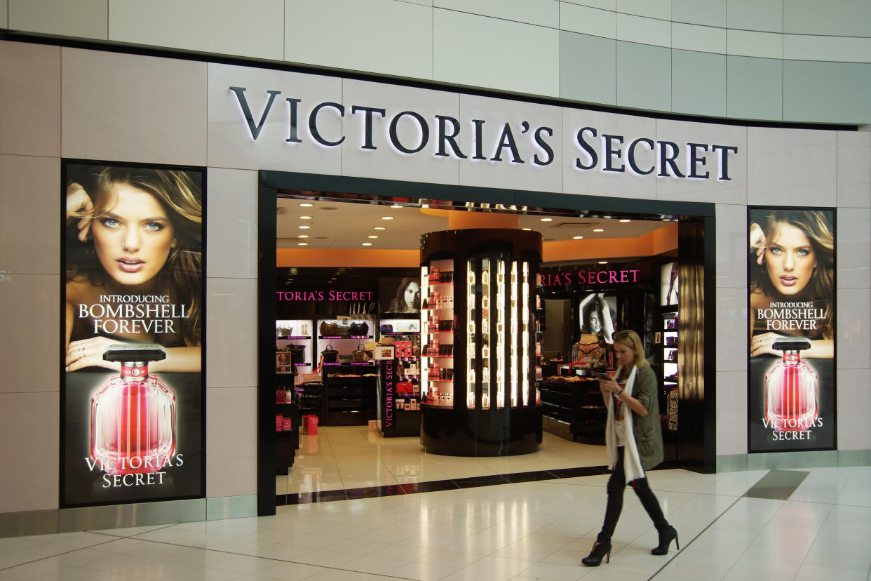 Sydney, Australia - August 9, 2013: A woman walks past a Victoria's Secret store in the departure hall of Sydney International Airport. This particular store has the distinction of being the lingerie retailer's first in Australia.
