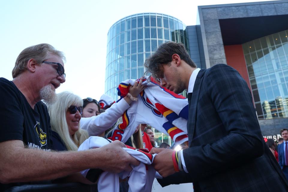 Oct 12, 2023; Newark, New Jersey, USA; New Jersey Devils center Jack Hughes (86) signs autographs for fans before their home opening game against the Detroit Red Wings at Prudential Center.