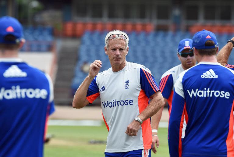Former England coach Peter Moores (C) talks to his the team during a training session at the Grenada National Stadium in Saint George's on April 20, 2015