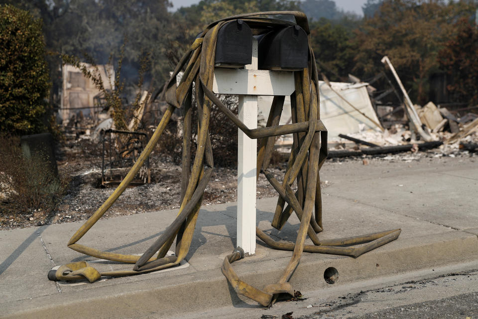 <p>Water hoses are seen on a post box at a neighborhood destroyed by the Tubbs Fire in Santa Rosa, Calif., Oct. 10, 2017. (Photo: Stephen Lam/Reuters) </p>