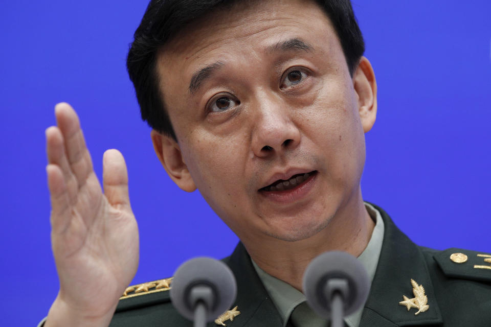 China's Defense Ministry spokesman Wu Qian gestures as he speaks during a press conference at the State Council Information Office in Beijing, Wednesday, July 24, 2019. China says it will not "renounce the use of force" in efforts to reunify Taiwan with the mainland and vows to take all necessary military measures to defeat "separatists." (AP Photo/Andy Wong)