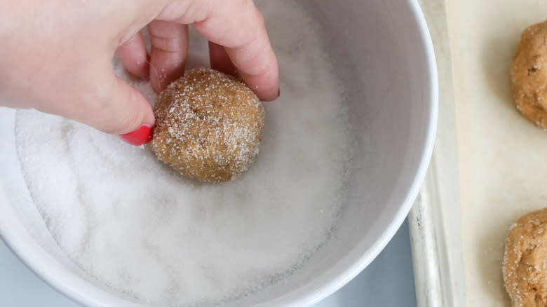 hand pinching raw cookie dough