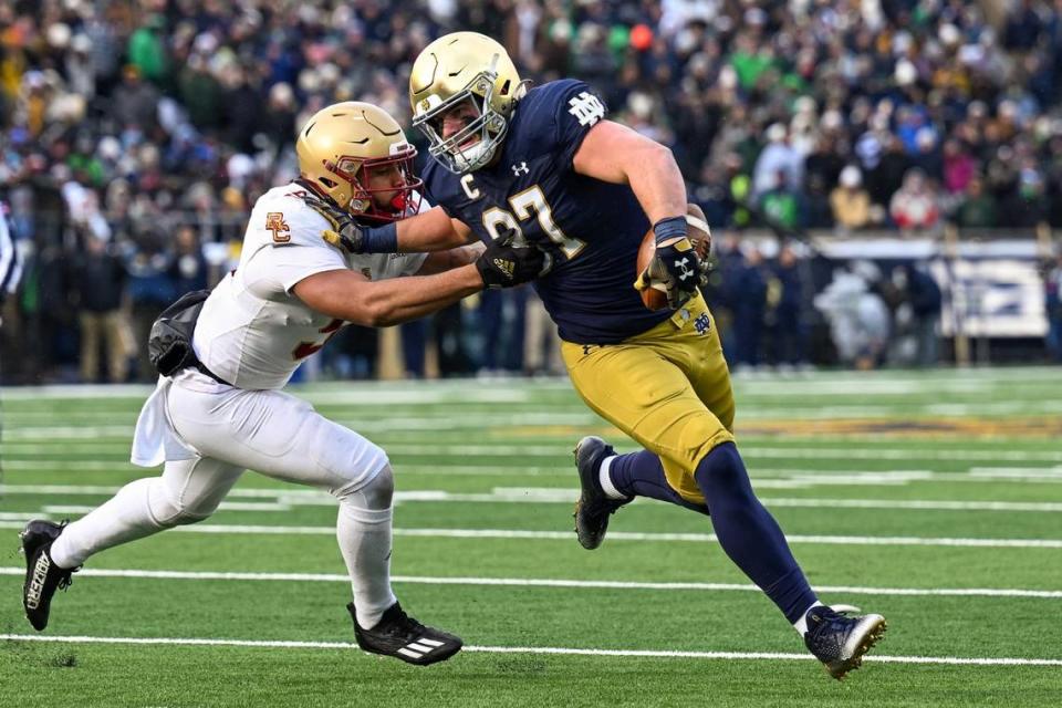 Notre Dame tight end Michael Mayer (87) picks up a first down at the expense of Boston College’s Jaiden Woodbey (9) at Notre Dame Stadium on Nov. 19, 2022, in South Bend, Indiana. (Quinn Harris/Getty Images/TNS)